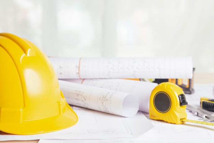 Work safety. Standard Construction site protective equipment on table wooden background, flat lay, copy space,safety first concepts.