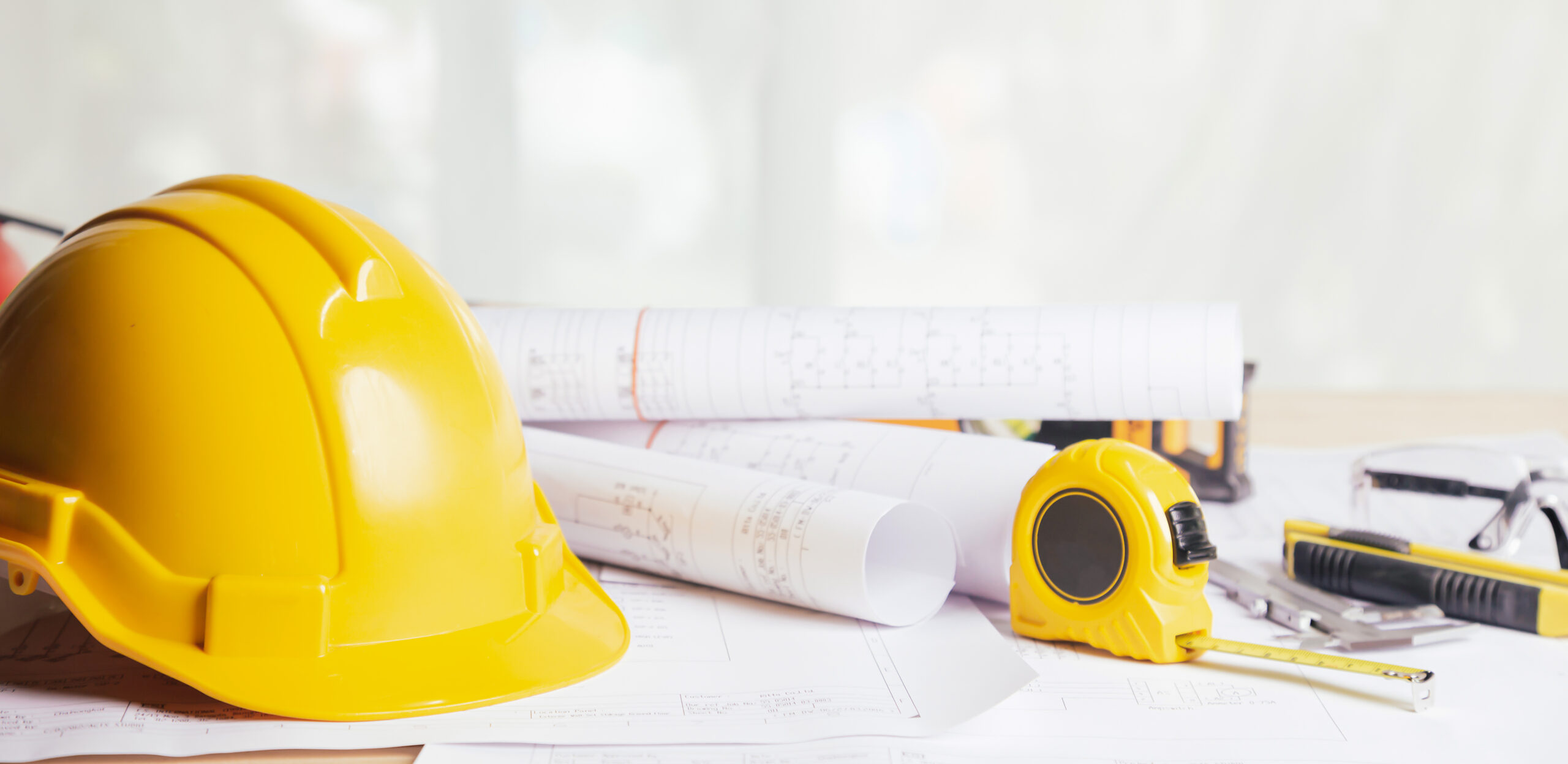 Work safety. Standard Construction site protective equipment on table wooden background, flat lay, copy space,safety first concepts.